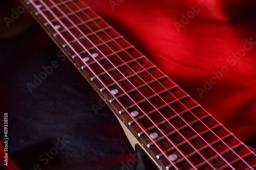 guitar fretboard illuminated by red light