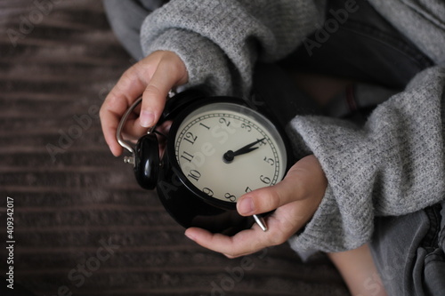 person holding clock