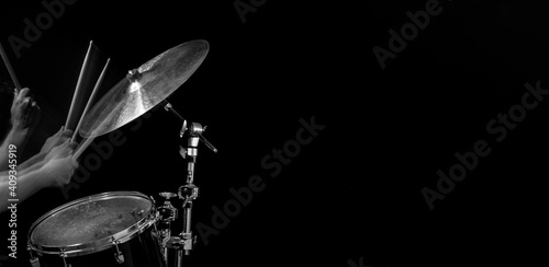 Stroboscopic drummer hitting cymbals with drum sticks