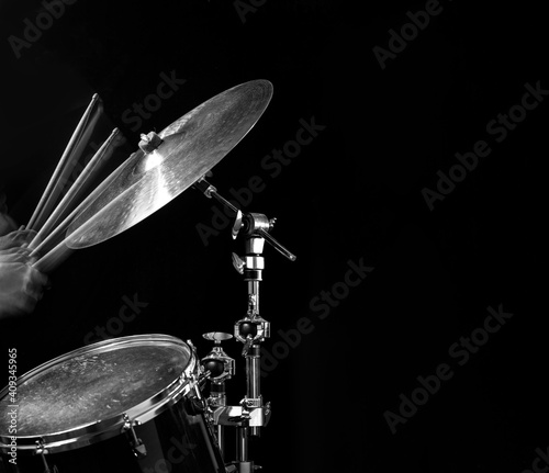 Stroboscopic drummer hitting cymbals with drum sticks