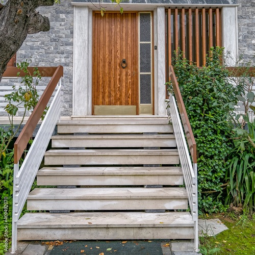 marble stairs to family house entrance natural wood door with transom window