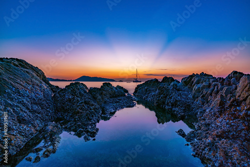 Beautiful sunrise or sunset seascape scenery over andaman sea in Phuket Thailand Epic dawn sea landscape with rocks in the foreground Long exposure image Amazing light of nature