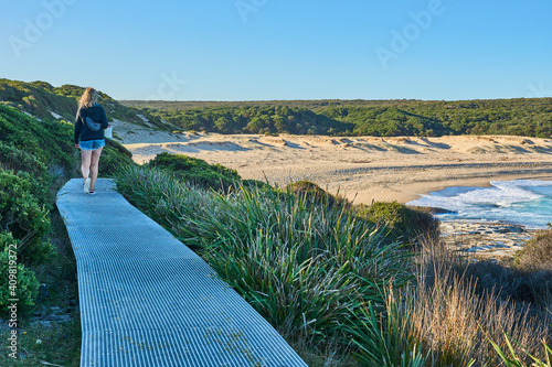 Royal National Park, Australia: Coastal Track at Marley Beach. Woman, female hiker walking the track. 