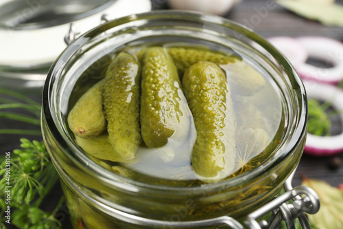 Glass jar of tasty pickled cucumbers, closeup