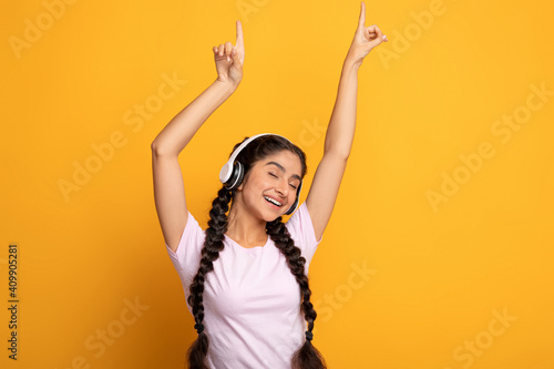 Smiling Young Indian Woman Listening To Music