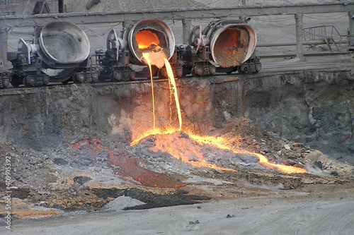 Pouring out the remains of blast furnace slag from the slag truck. Blast furnace production.