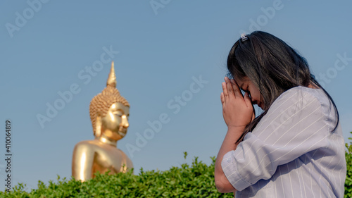 Women pay respect to Buddha images in temples, Thailand