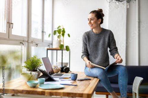Young female freelancer working in loft office 