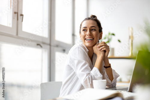 Creative young woman working on laptop in her studio 