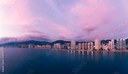 Beautiful sunset, aerial view of the beach, acapulco city seen from above. Travel and vacation concept. Colorful sunset on the beach