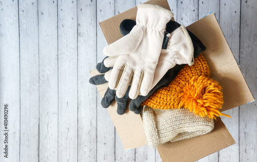 donations to the needy, warm clothes in a cardboard box