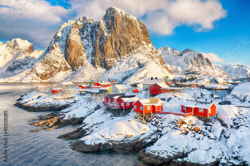 Picturesque winter view on Hamnoy village and Festhaeltinden mountain on background.