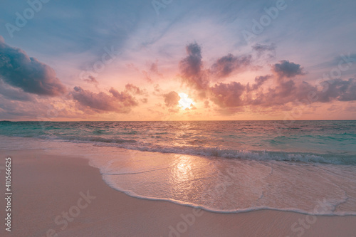 Closeup sea sand beach. Panoramic beach landscape. Inspire tropical beach seascape horizon. Orange and golden sunset sky calmness tranquil relaxing sunlight summer mood. Vacation travel holiday banner