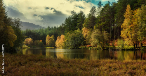 Autumn woods on a lake in the mountains