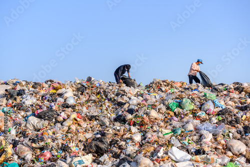 Poor people collect garbage for sale People living in garbage heaps walking to collect recyclable waste to be sold to poverty concept world environment day