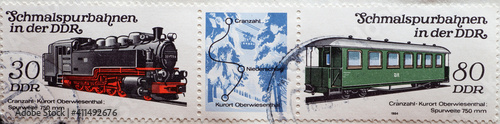 GERMANY, DDR - CIRCA 1984 : a postage stamp from Germany, GDR showing two narrow-gauge railways in the GDR: historical locomotive 99 1775 and passenger car KB4