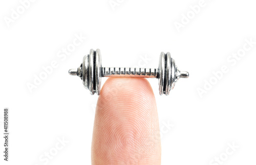 Cropped view of a tiny dumbbell on a fingertip isolated on white