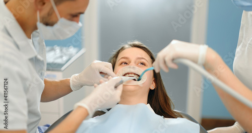 Young dentist wearing optragate for the young patient, preparing for the dental checkup. Regular visit to the orthodontist. 4k video screenshot, please use in small size