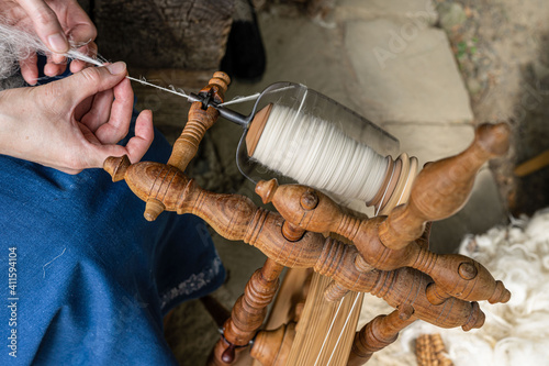 The thread maker makes the thread on the spinning wheel