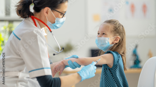 Doctor vaccinating child