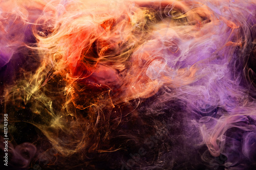 Color smoke background. Paint in water splash. Fantasy design. Spiritual energy. Bright orange violet steam wave mix floating on dark.