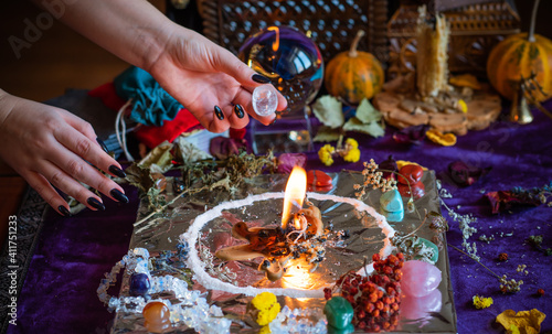 Candle burns a herb on the altar, magic among candles, clean negative energy, wicca concept