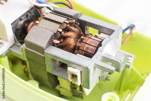Broken electric motor in a household appliance hand mixer. Malfunction of the rotor and stator of electrical components, close-up