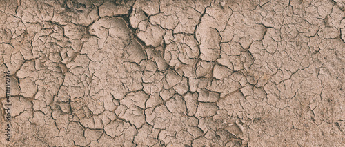 Background Of Brown Dry Cracked Soil Dirt Or Earth During Drought. Dry Cracked Earth Depicting Severe Drought Conditions. Panorama