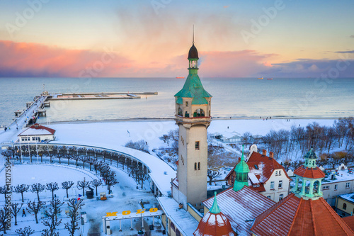 Beautiful sunset over the snowy beach and pier (Molo) in Sopot at winter. Poland