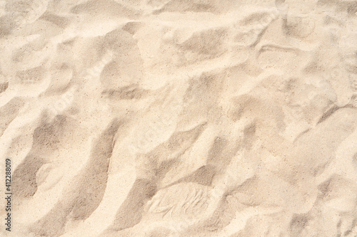 Sand on the beach for background. Brown beach sand texture as background. Close-up.