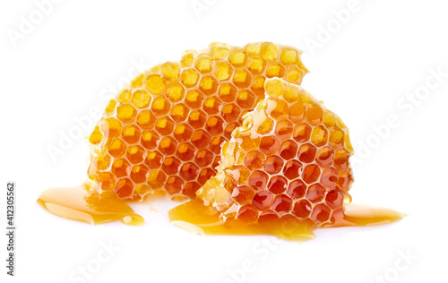 Honeycomb with honey drop on white background