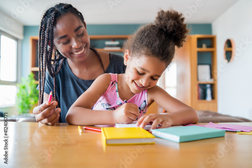 A father helping her daughter with homeschool.