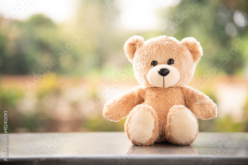 Teddy bear on wooden and blurred background 