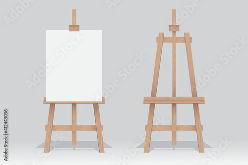 Wooden easel stand with blank canvas on white background