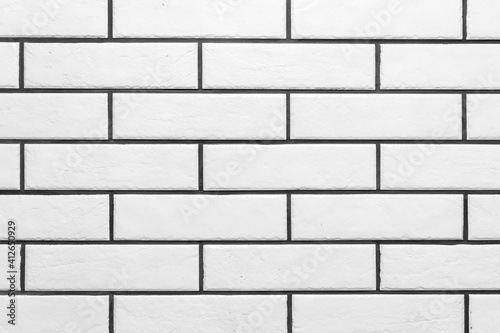 The texture of the white clean brick with black grout