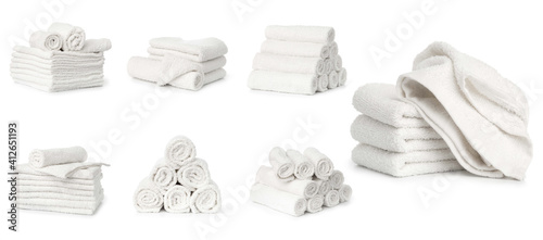 set of white spa towels stacked and in basket isolated on white background