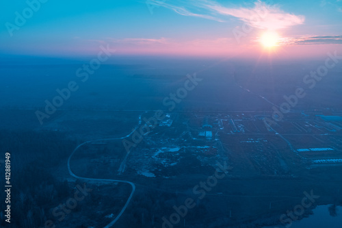Rural landscape in the morning with the blue-pink sky. Aerial view of the countryside during sunrise