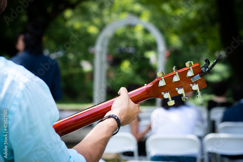 Back of a guitar player at a wedding ceremony