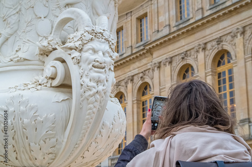 Taking a photo of a sculpture in the Gardens of the Palace of Versailles - historical, royal.