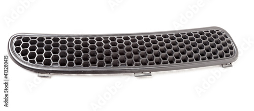 Hood ventilation grille with windscreen washer in black on white isolated background. Used spare parts from junkyard catalog.