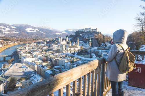 Enjoying the view over Salzburg: Young tourist woman on the viewing platform