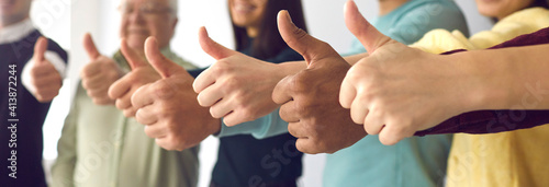 We recommend it. Close up of people of all ages showing thumbs up as a symbol of recommendation and approval. Concept of approving a consultation, service or product. Selective focus.