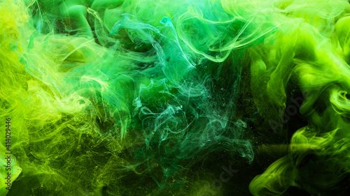 Neon smoke. Colorful background. Ink in water splash. Poison fume abstract design. Glowing vibrant green yellow steam blend with chemical dust effect on dark.