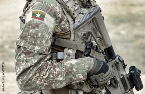 Soldier with assault rifle and flag of Myanmar and also known as Burma on military uniform. Collage.