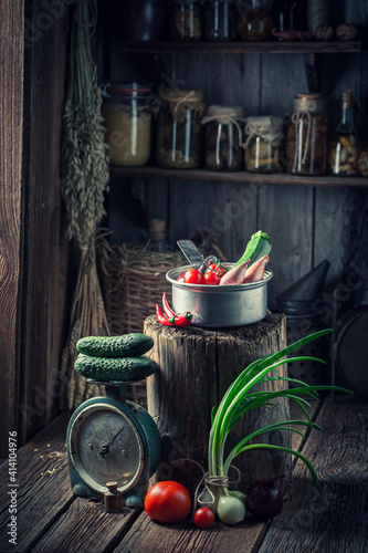 Wooden cellar with vegetables and preserves in jars