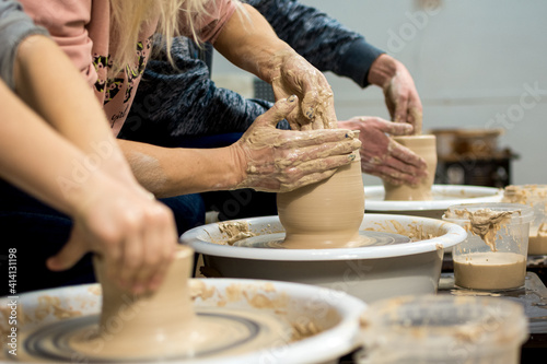 Master class on modeling of clay on a potter's wheel In the pottery workshop