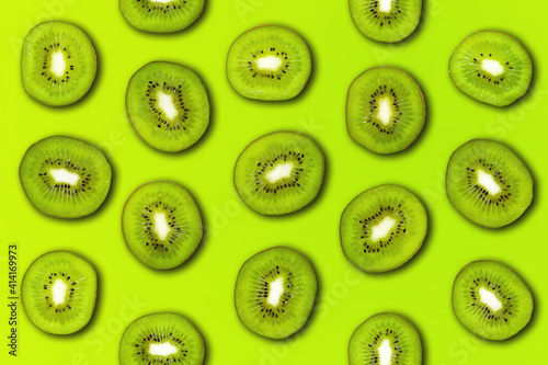 Slice of green raw kiwi fruit pattern background. Flat lay, trendy juicy color.
