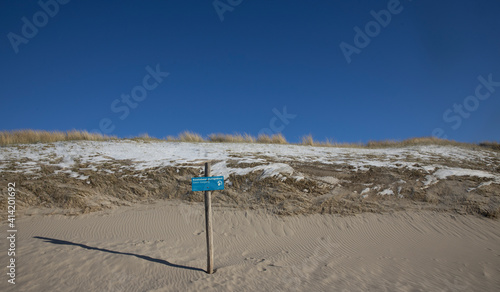Beach and dunes. Sign vulnerable area. in winter. Julianadorp Northsea coast Netherlands.