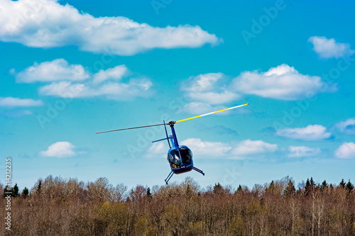 helicopter robinson 44 flies in the sky