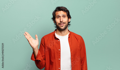 young handsome indian man feeling happy, surprised and cheerful, smiling with positive attitude, realizing a solution or idea